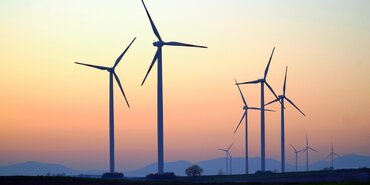 Wind turbines by a setting sun