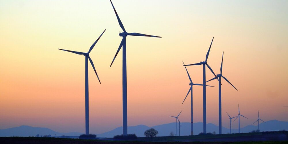 Wind turbines by a setting sun