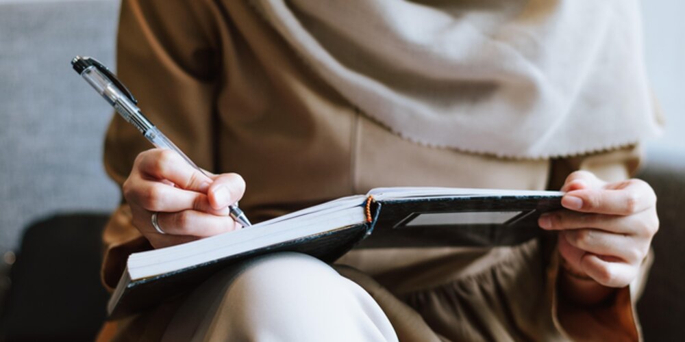 A woman writing in a book